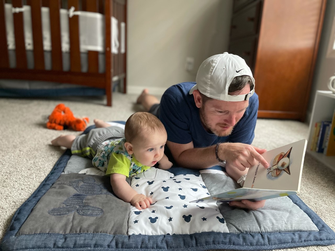 Best of Imagination Library - Baby and dad reading on blanket. 
