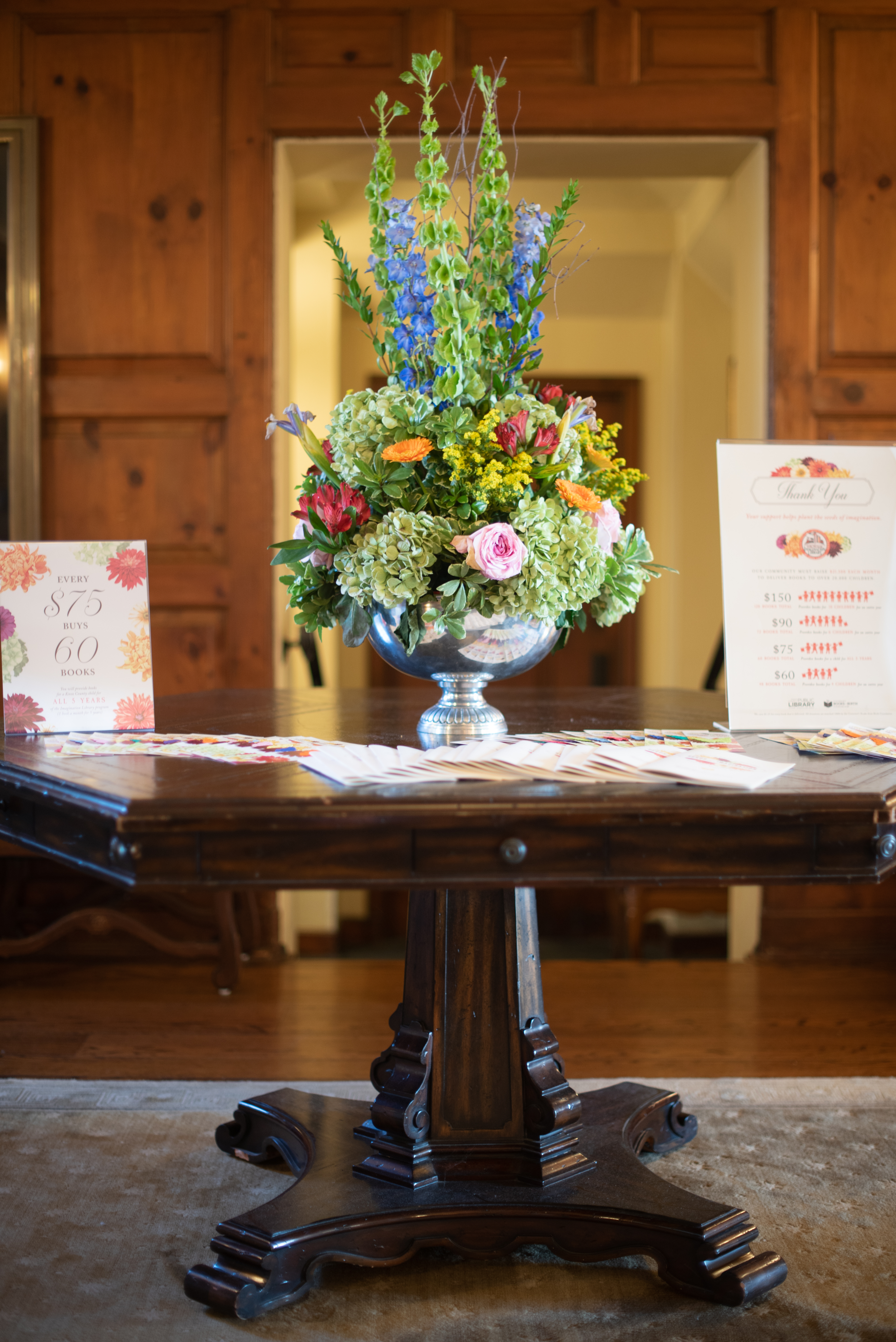  Floral arrangement and sponsor signs at the Seeds of Imagination Luncheon 2019.