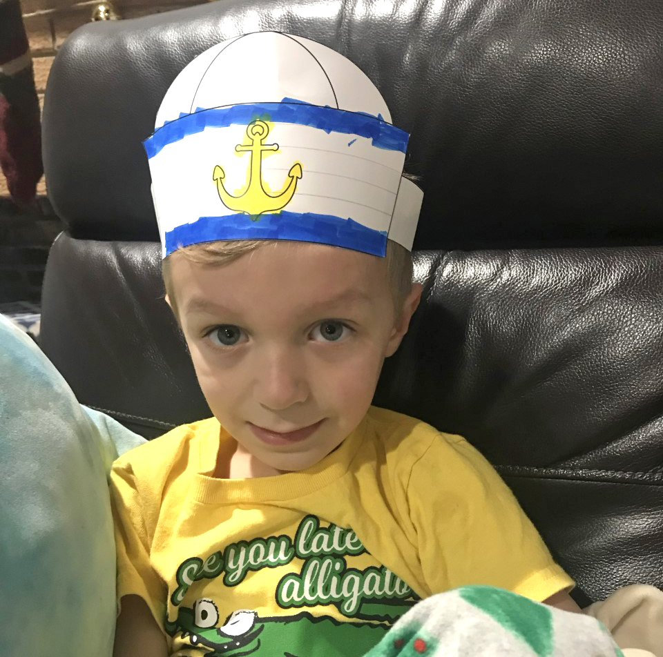 Young boy wearing his finished sailor hat craft