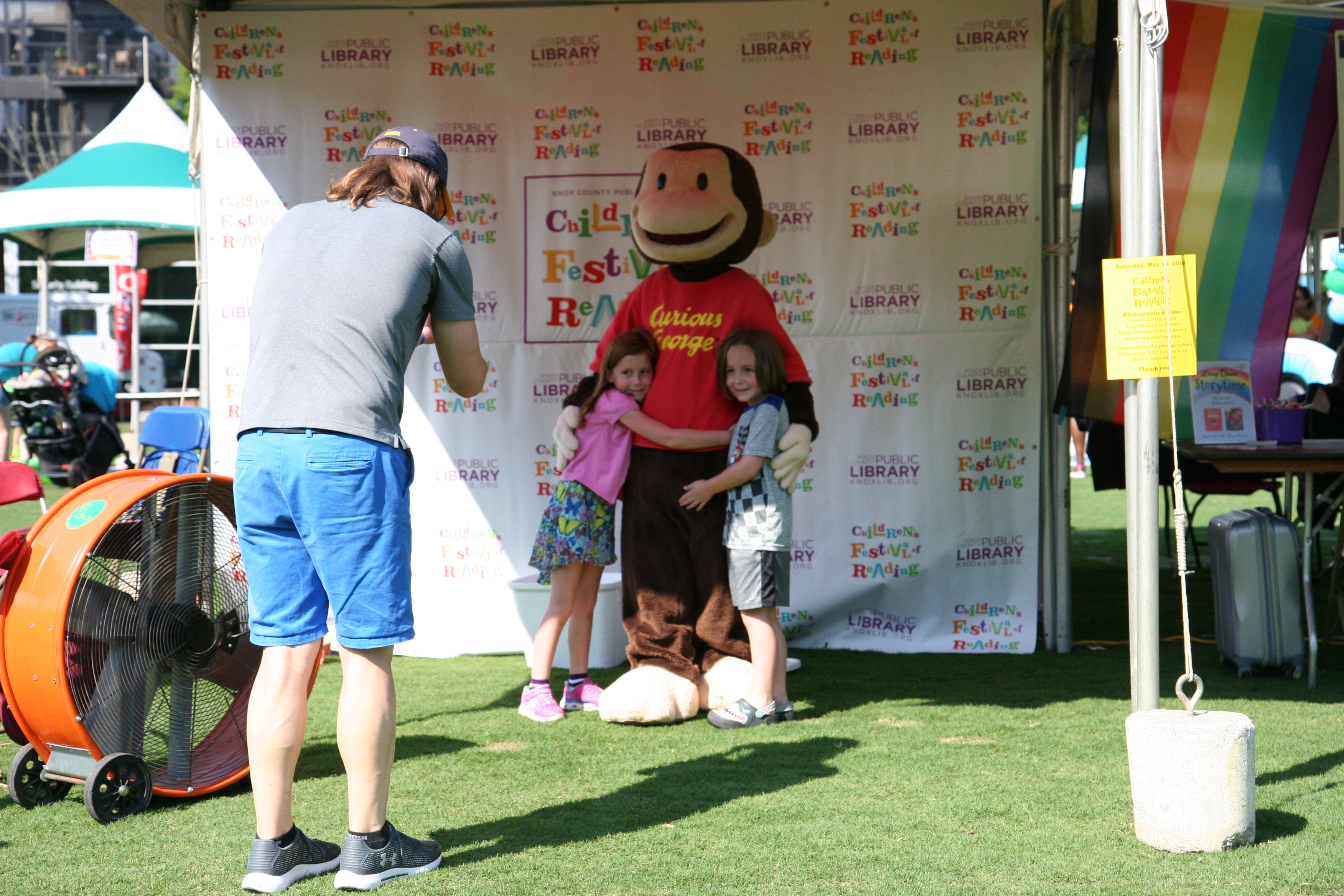 Curious George posing with kids