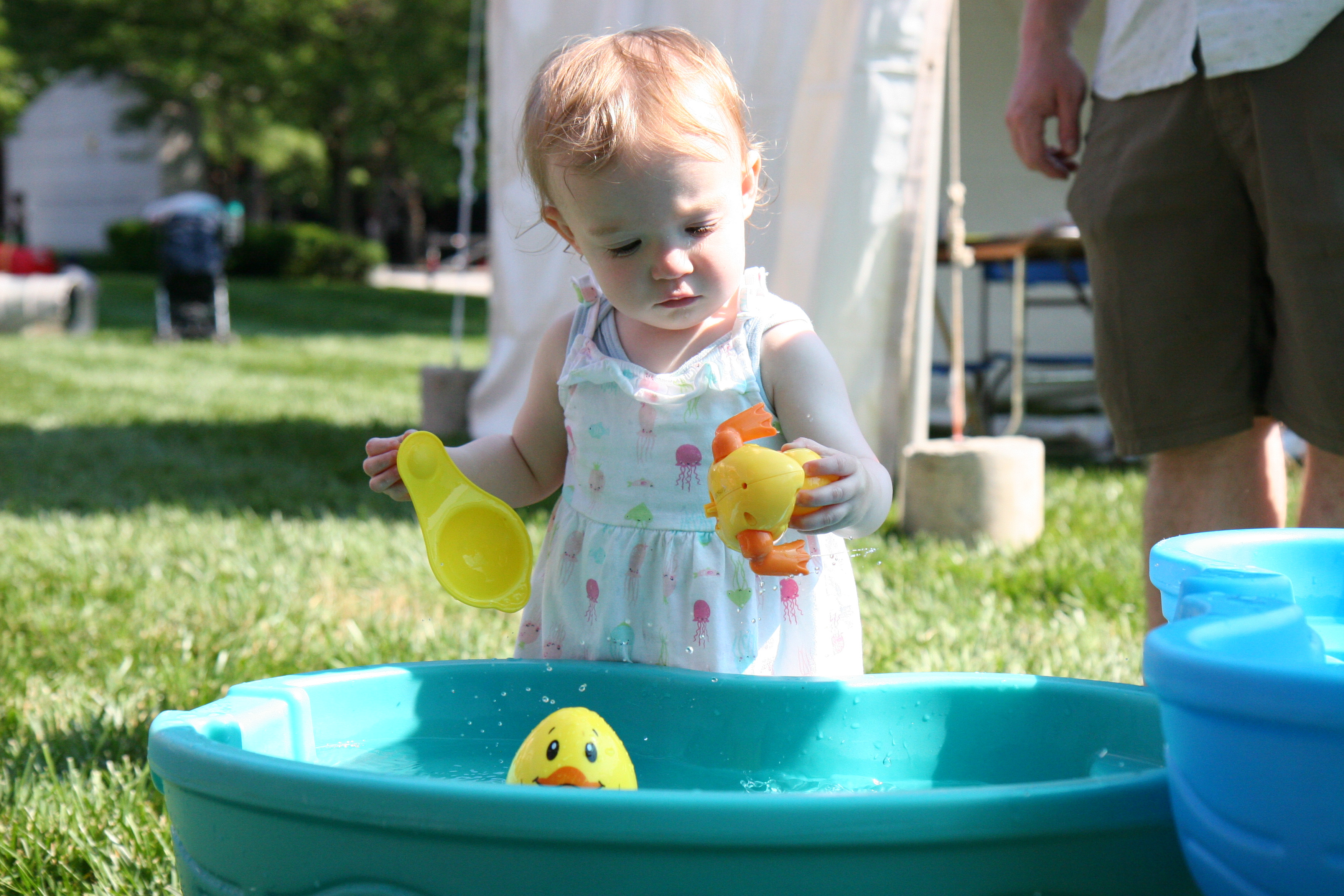 Little baby playing with toy ducks at the Children's Festival of Reading
