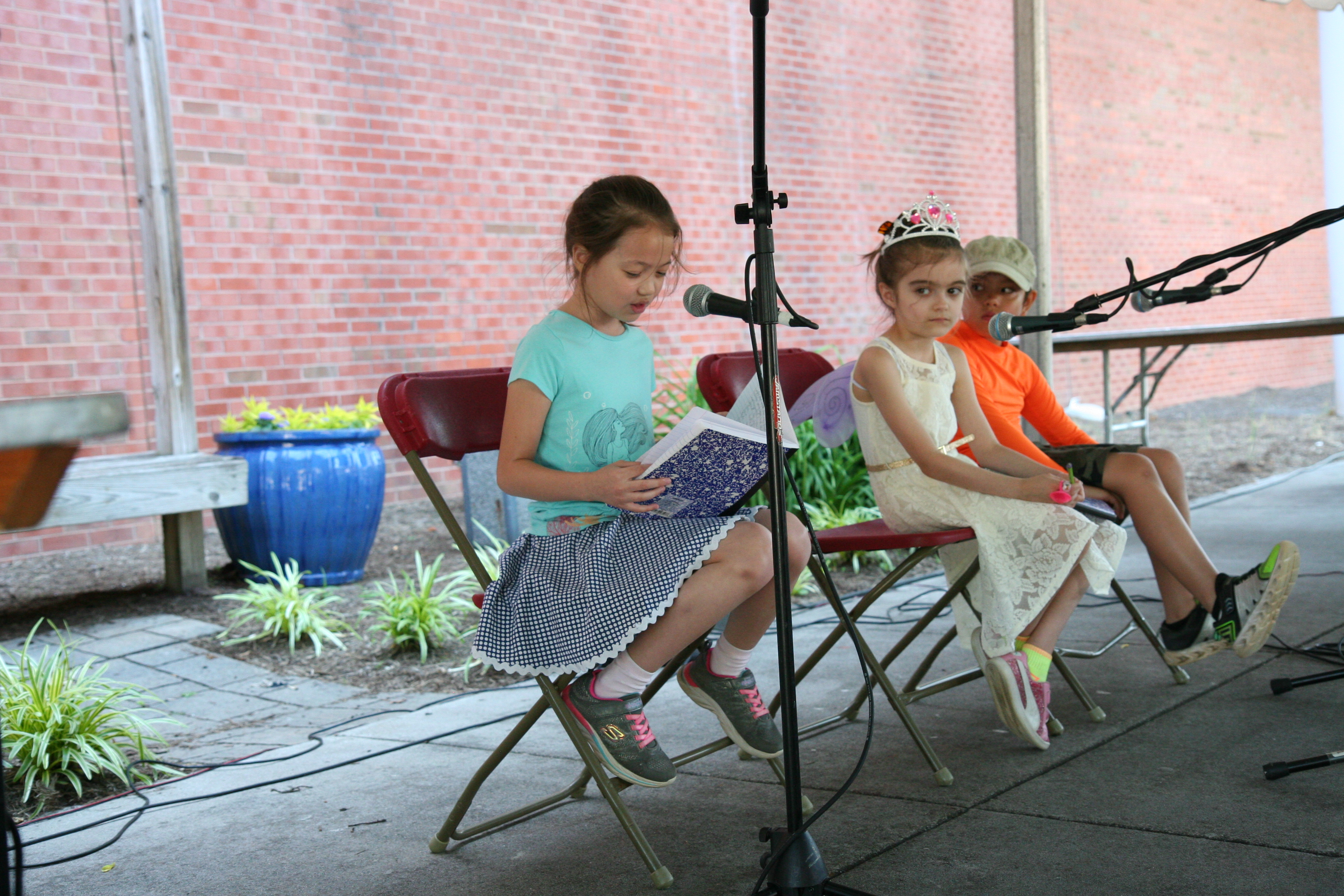 Young girl reading to audience at the Children's Festival of Reading