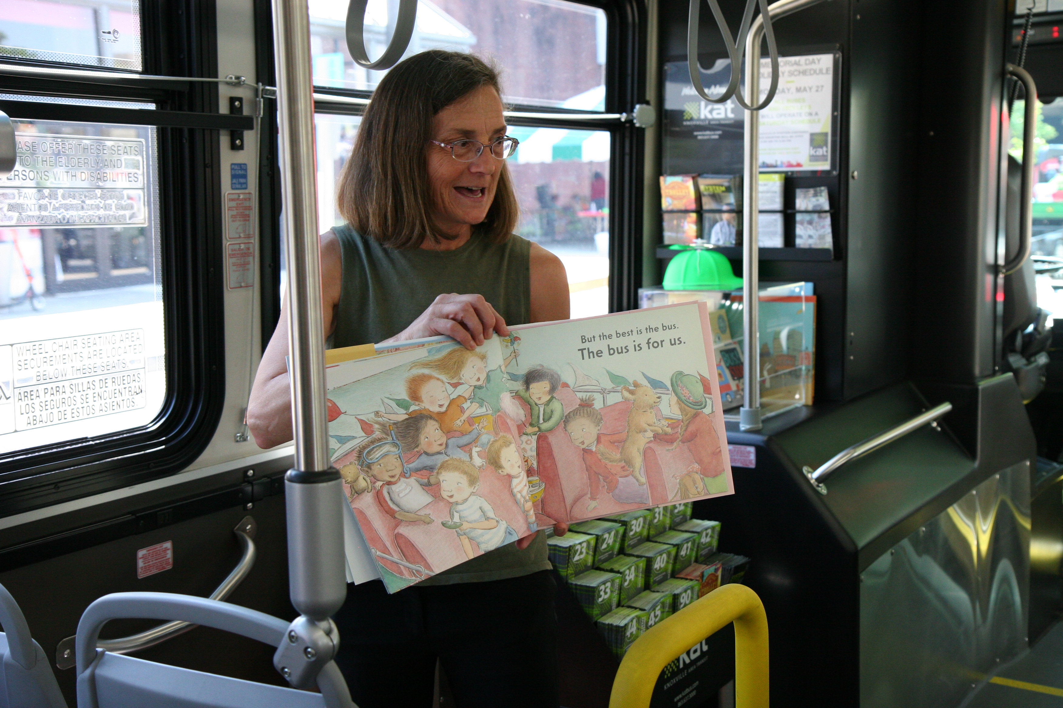 Woman reading to children on bus