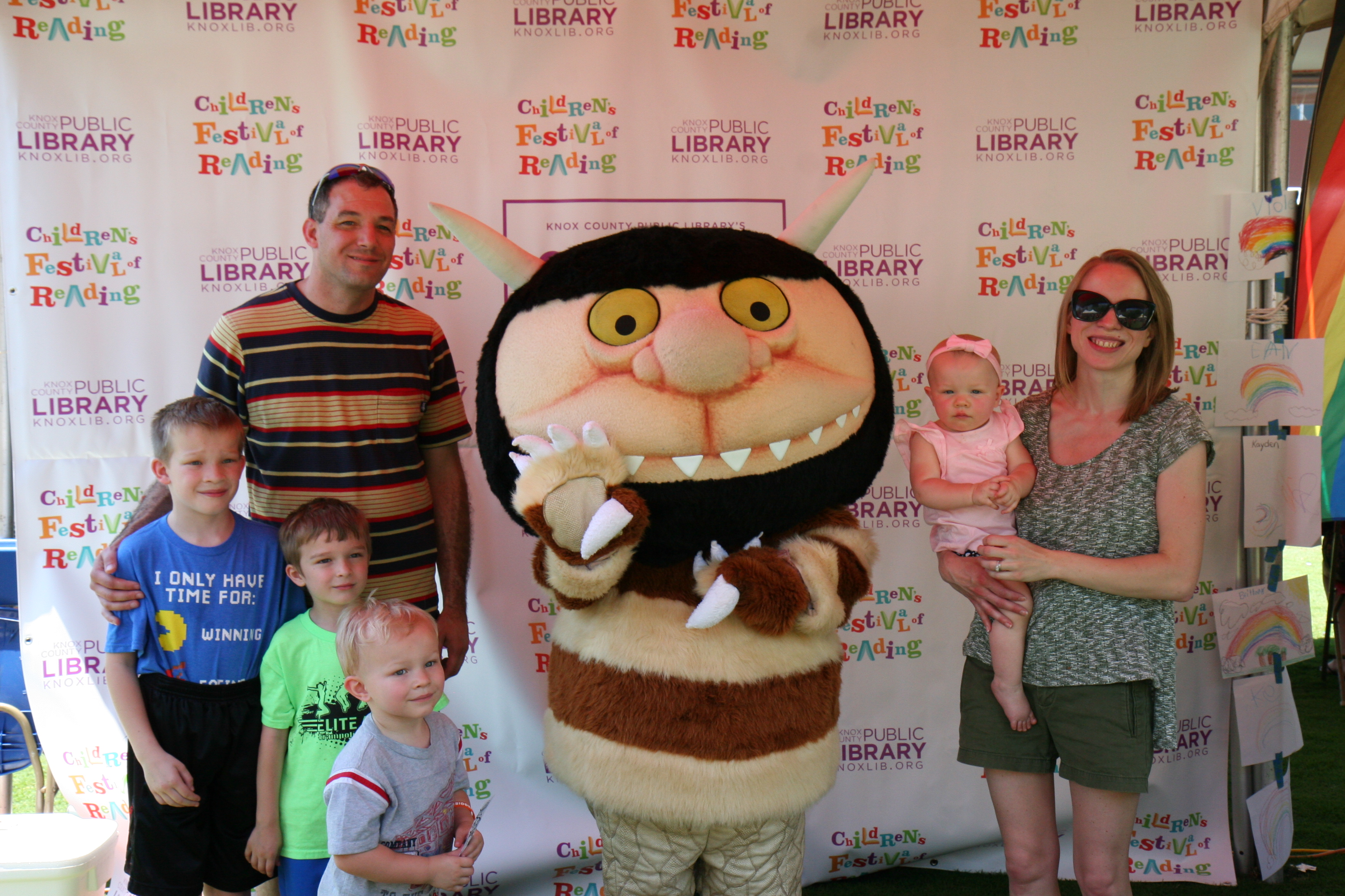 Family posing with the creature from Where the Wild Things Are