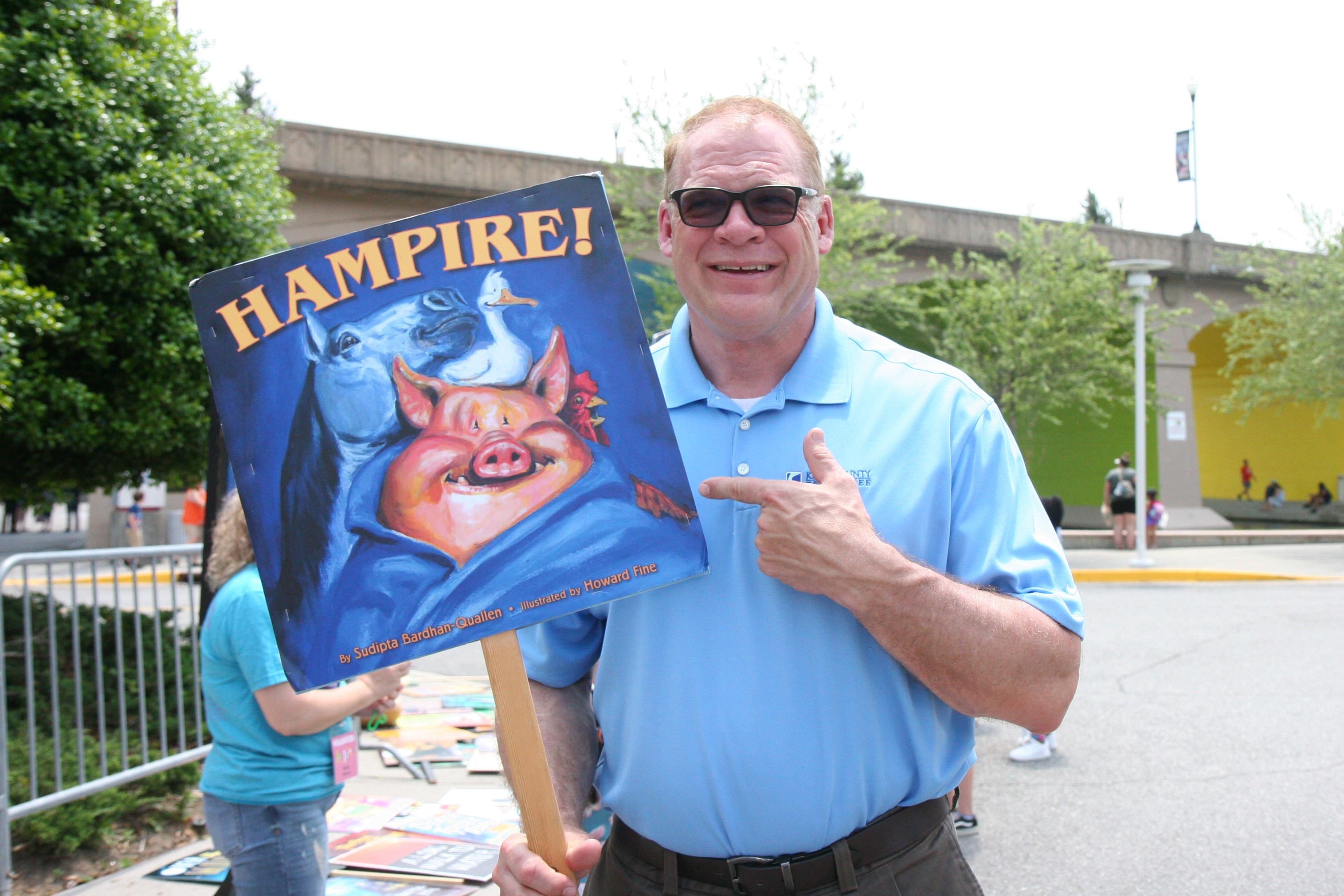 Mayor Jacobs holds an enlarged book cover of Hampire
