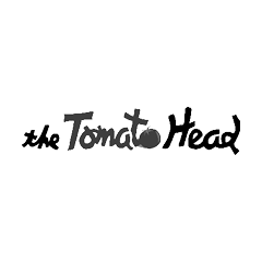 The Tomato Head black, gray, and white logo