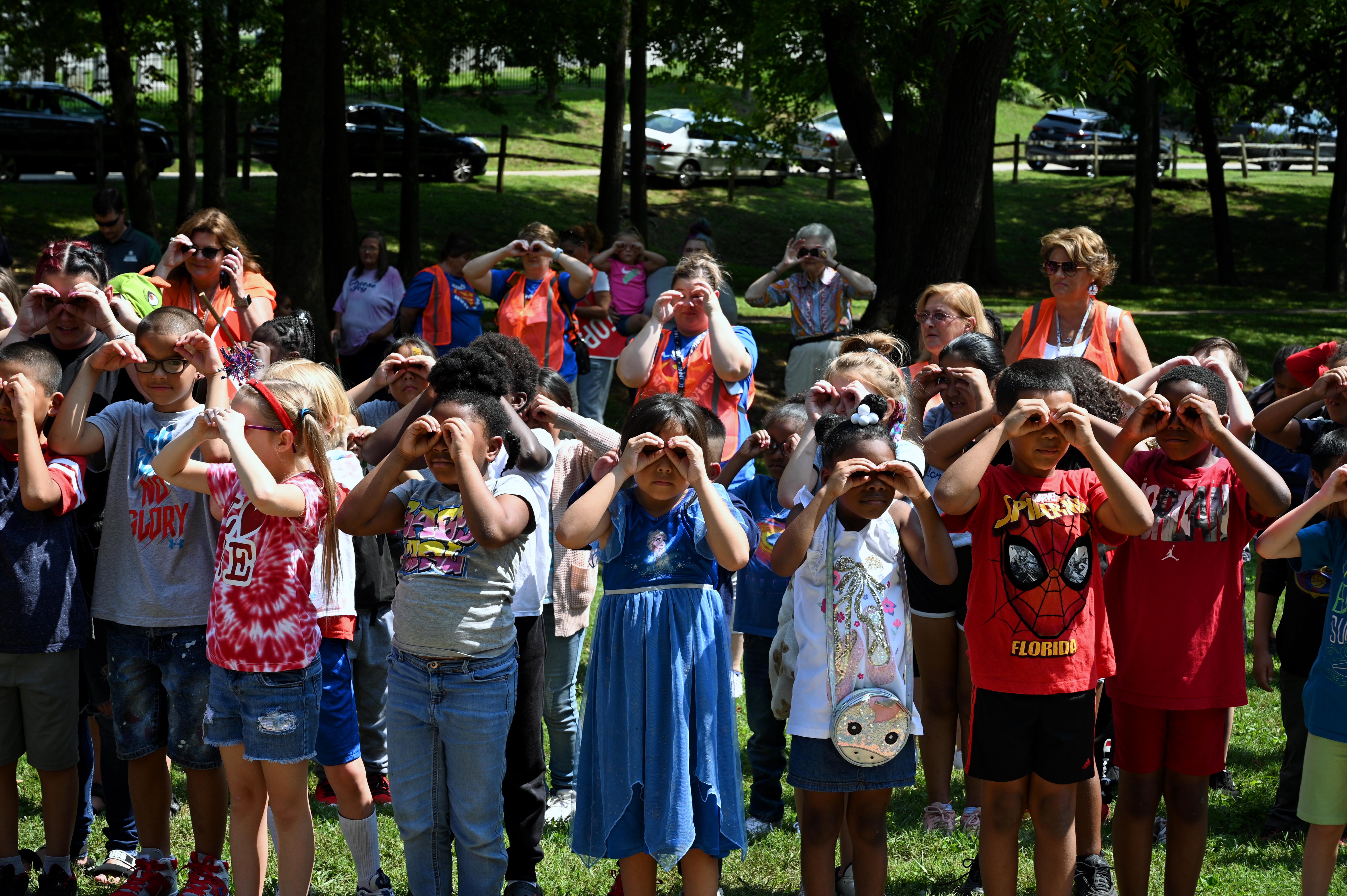 photo of elementary students making pretend binoculars