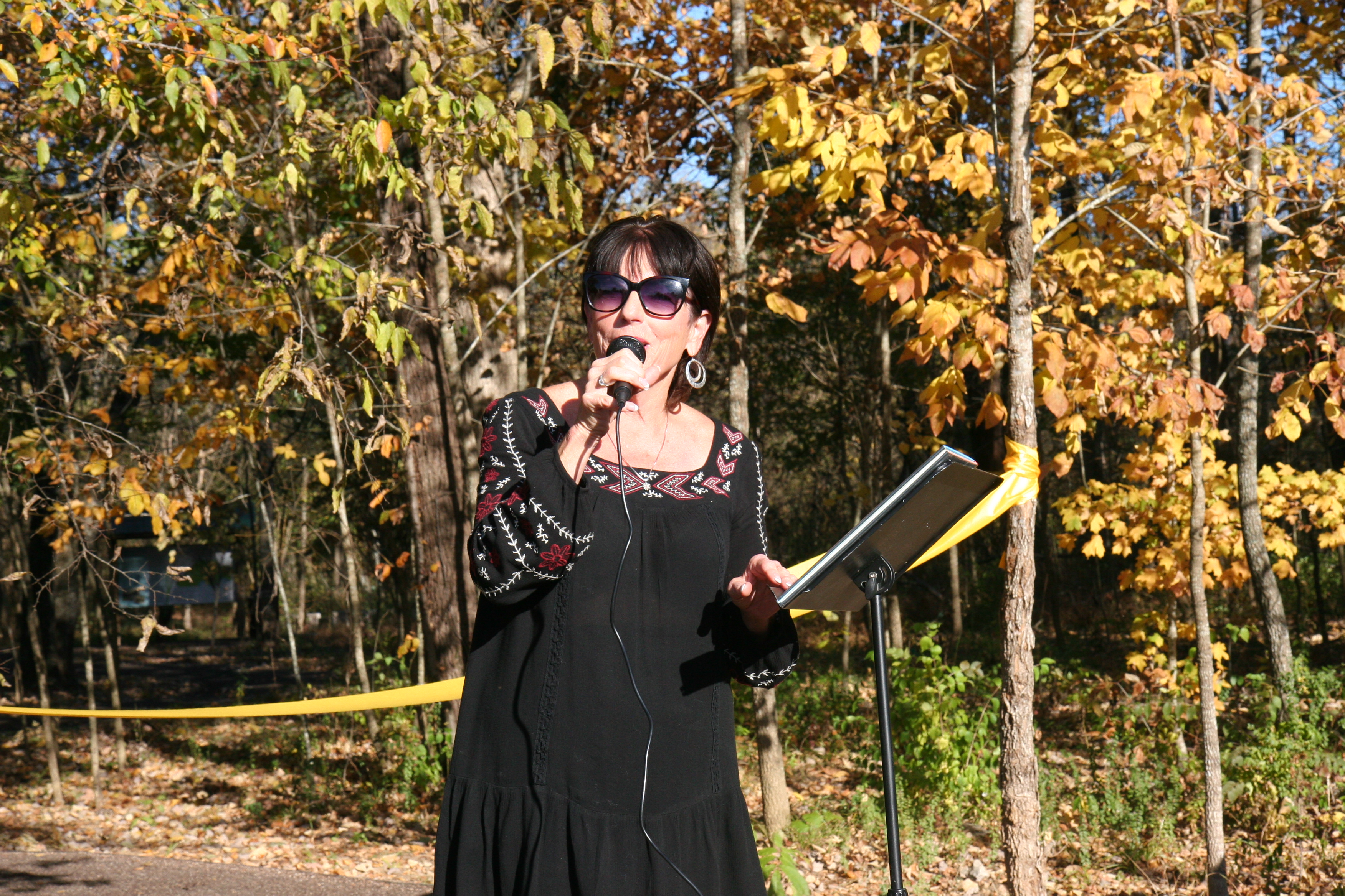 Carol Evans holding a microphone