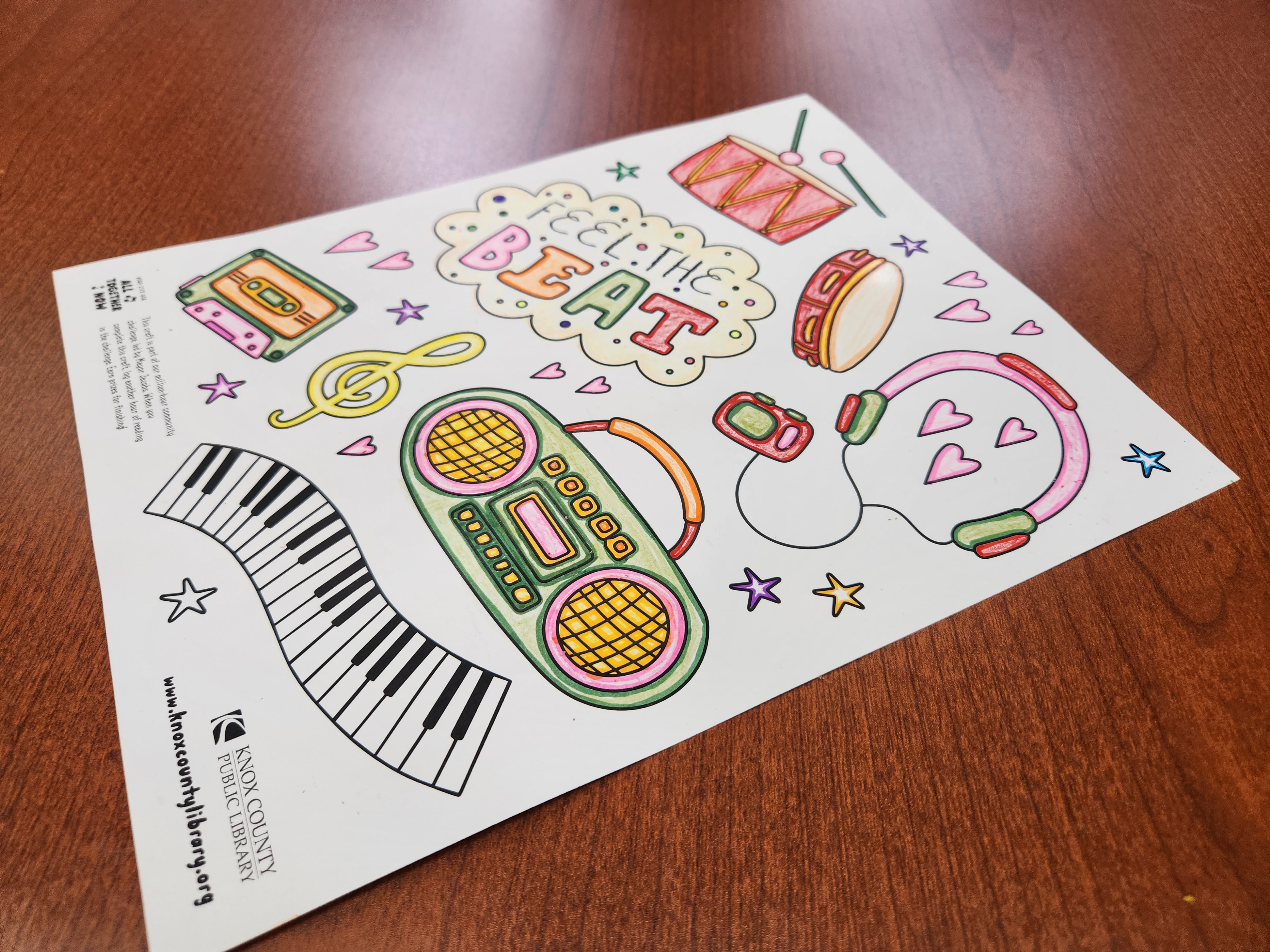 photo of coloring sheet with boombox, piano, headphones, cassette tape, drums