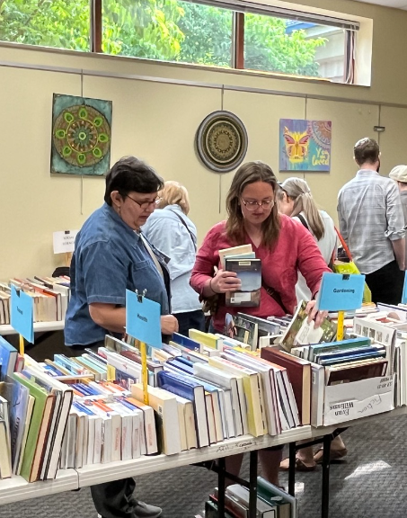 Two people browsing books at a Used Book Sale