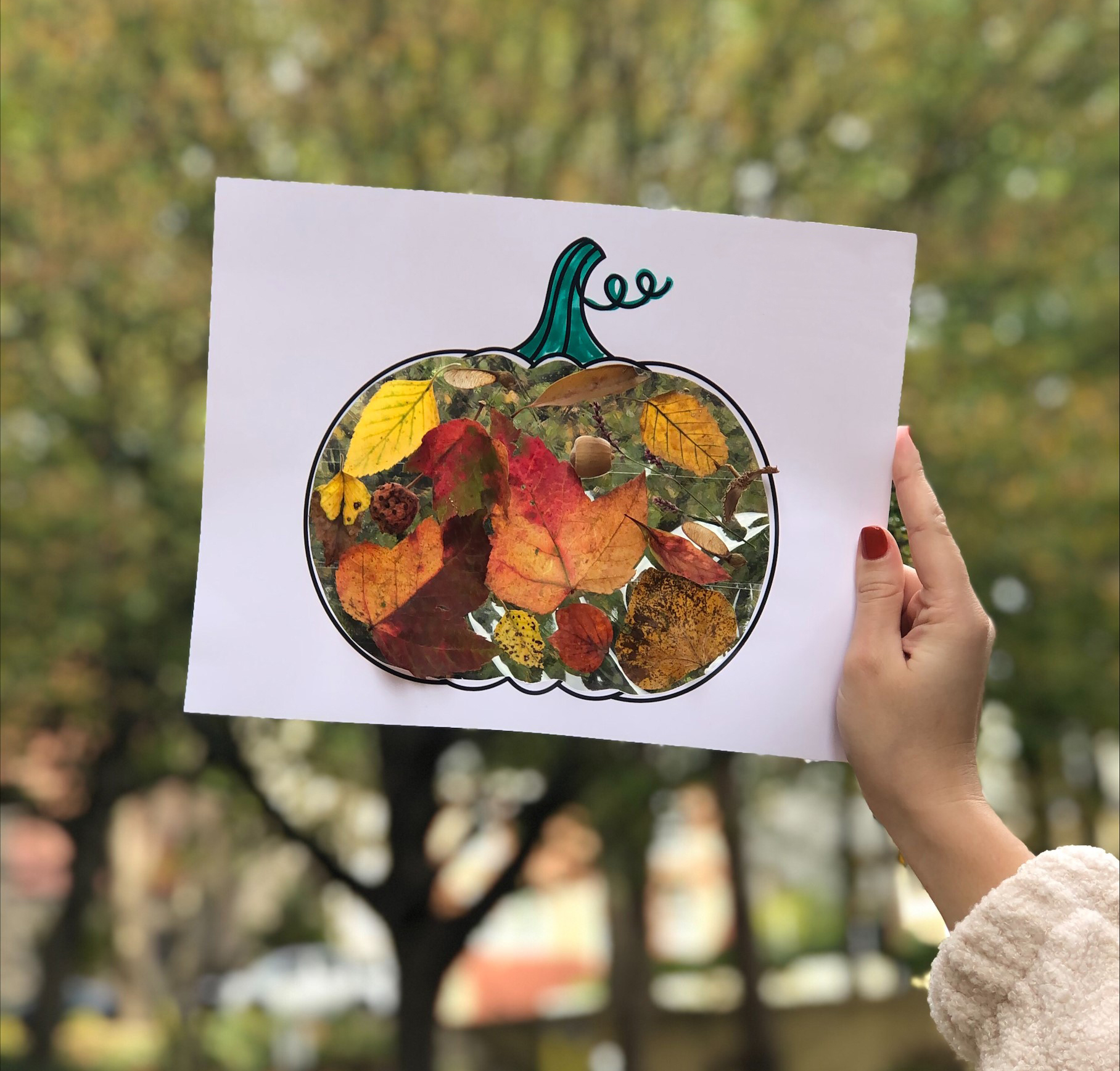 photo of pumpkin shaped craft filled with leaves