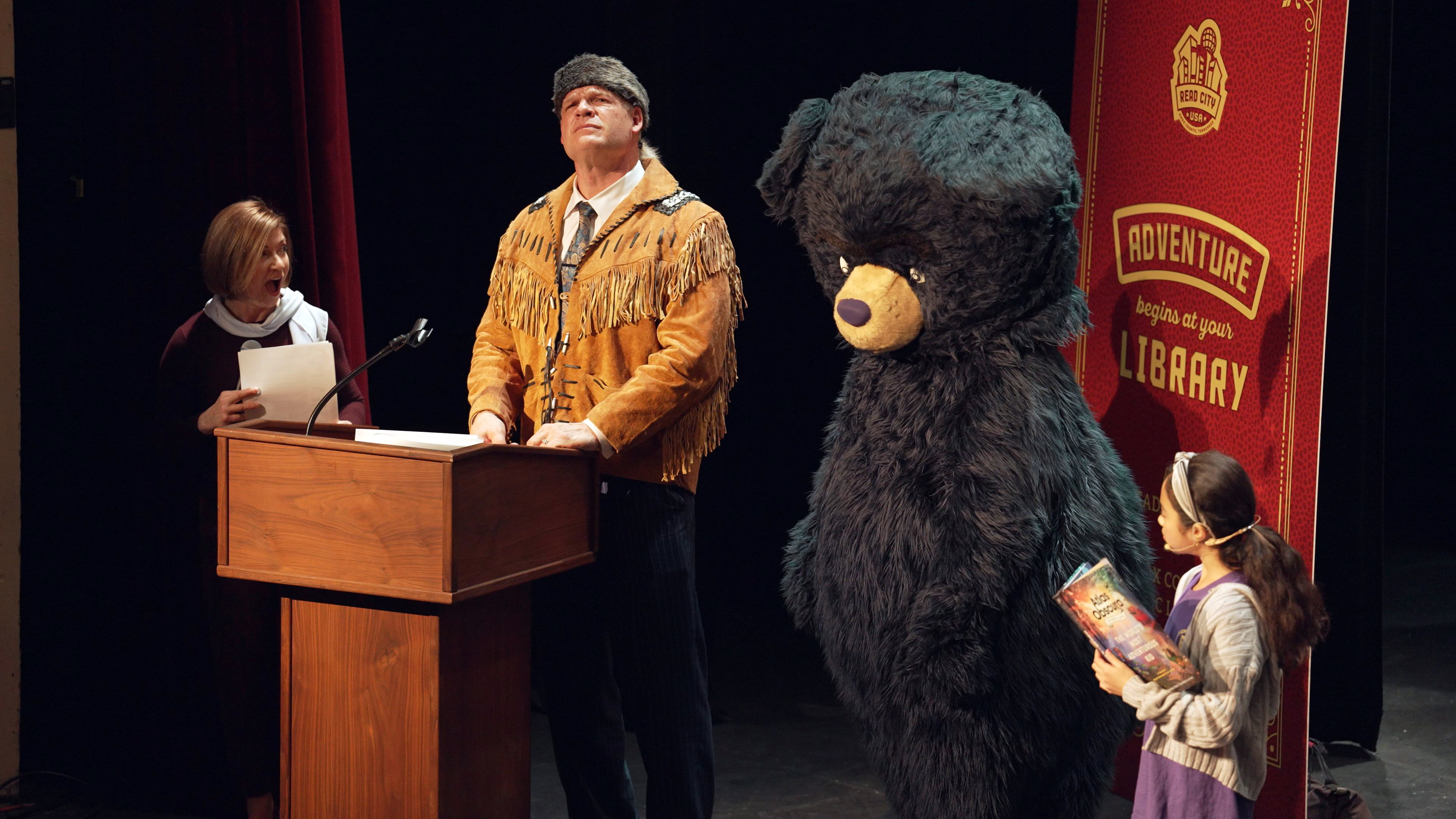 Mayor Glenn Jacobs wears a fringed frontier jacket with a costume bear character