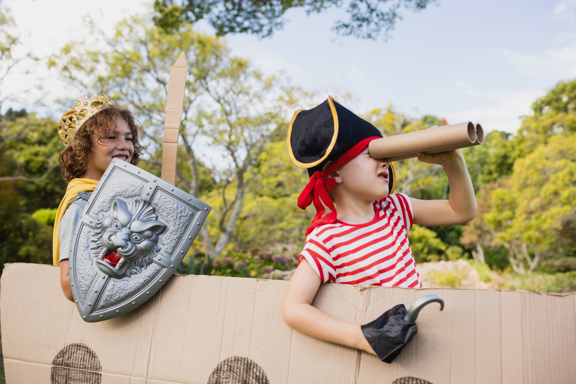 kids playing in cardboard pirate ship