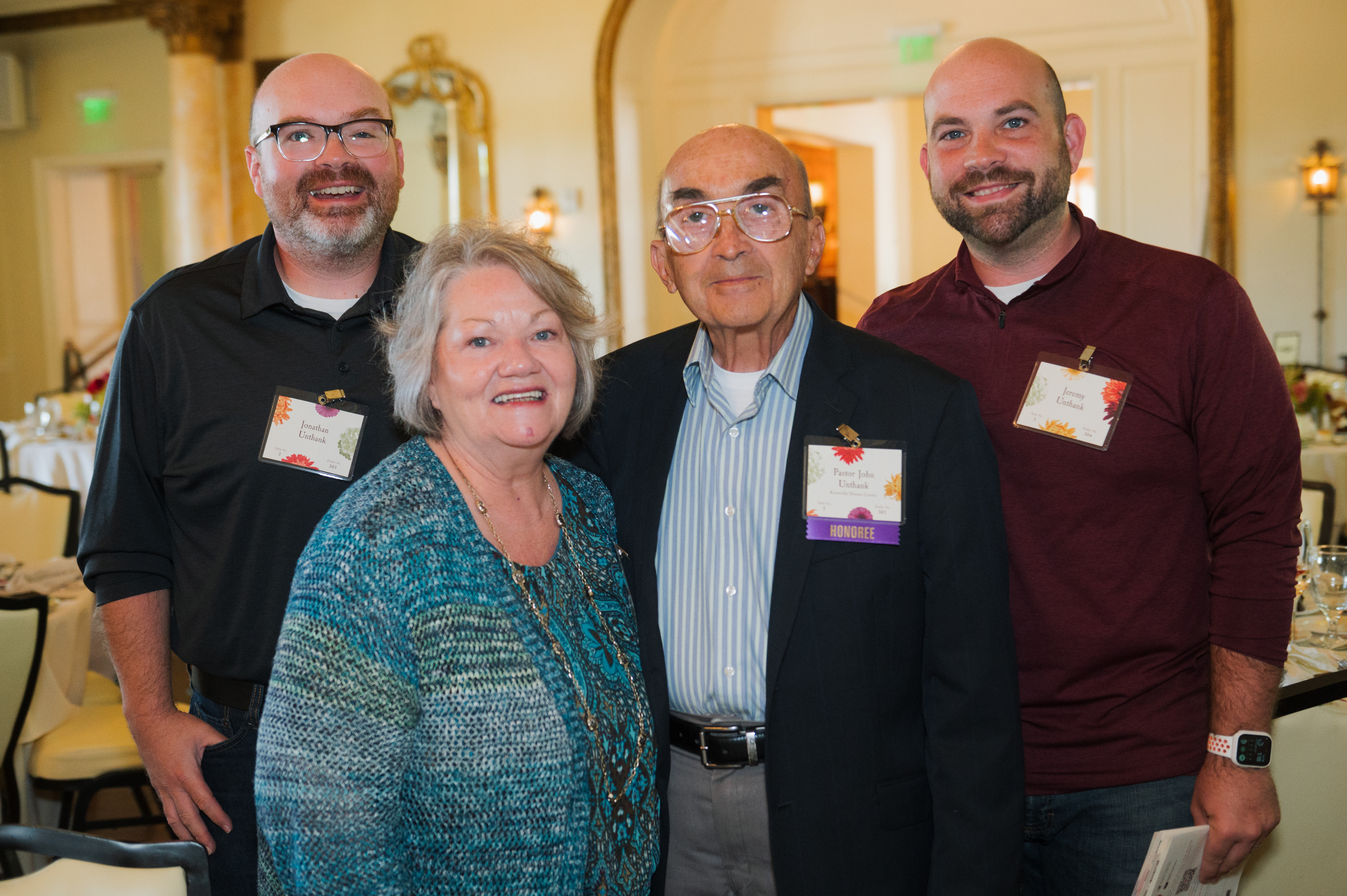 Pastor John, his wife, and his two sons pose for a family portrait