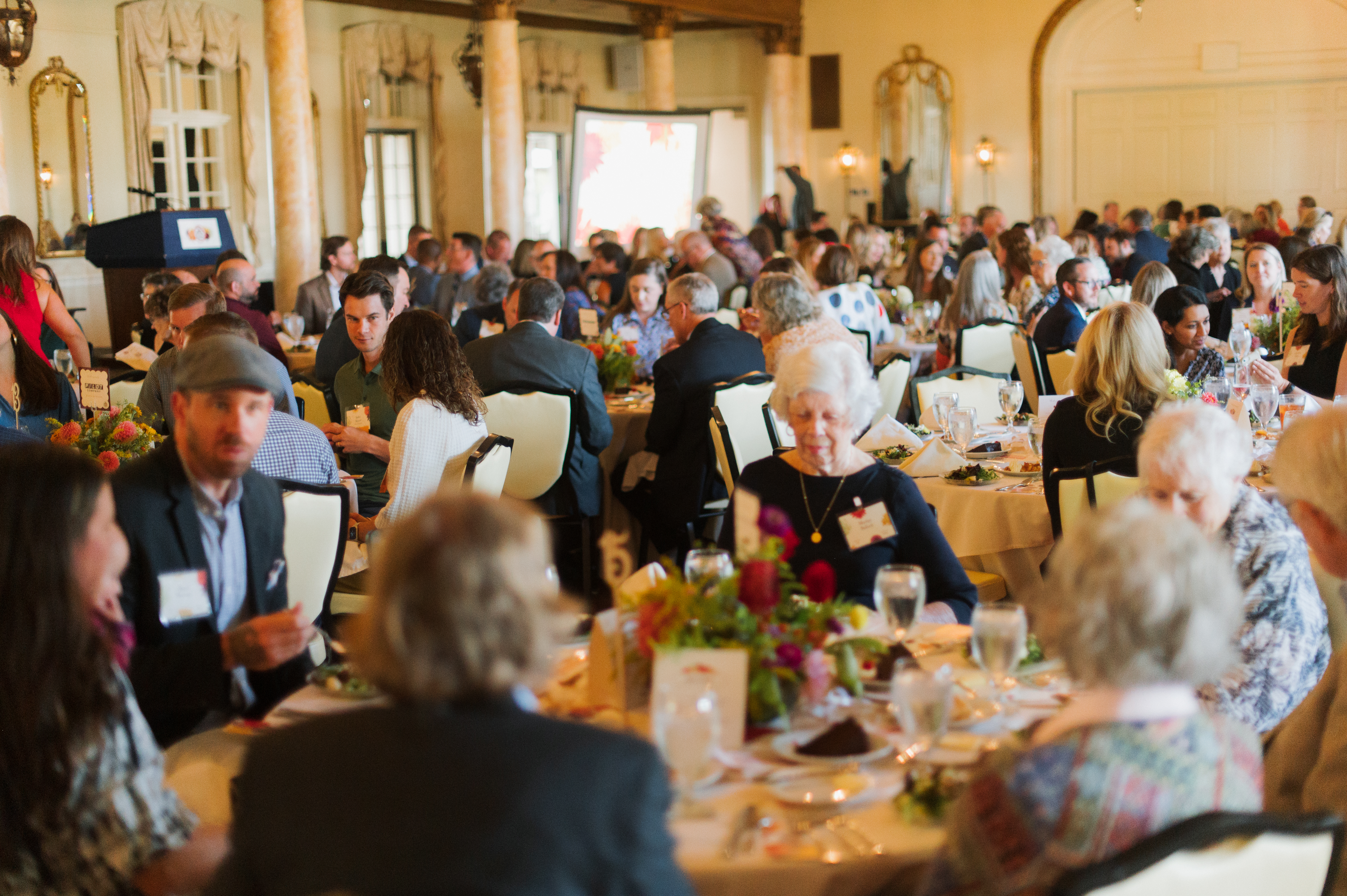 A sunlit dining room full of people