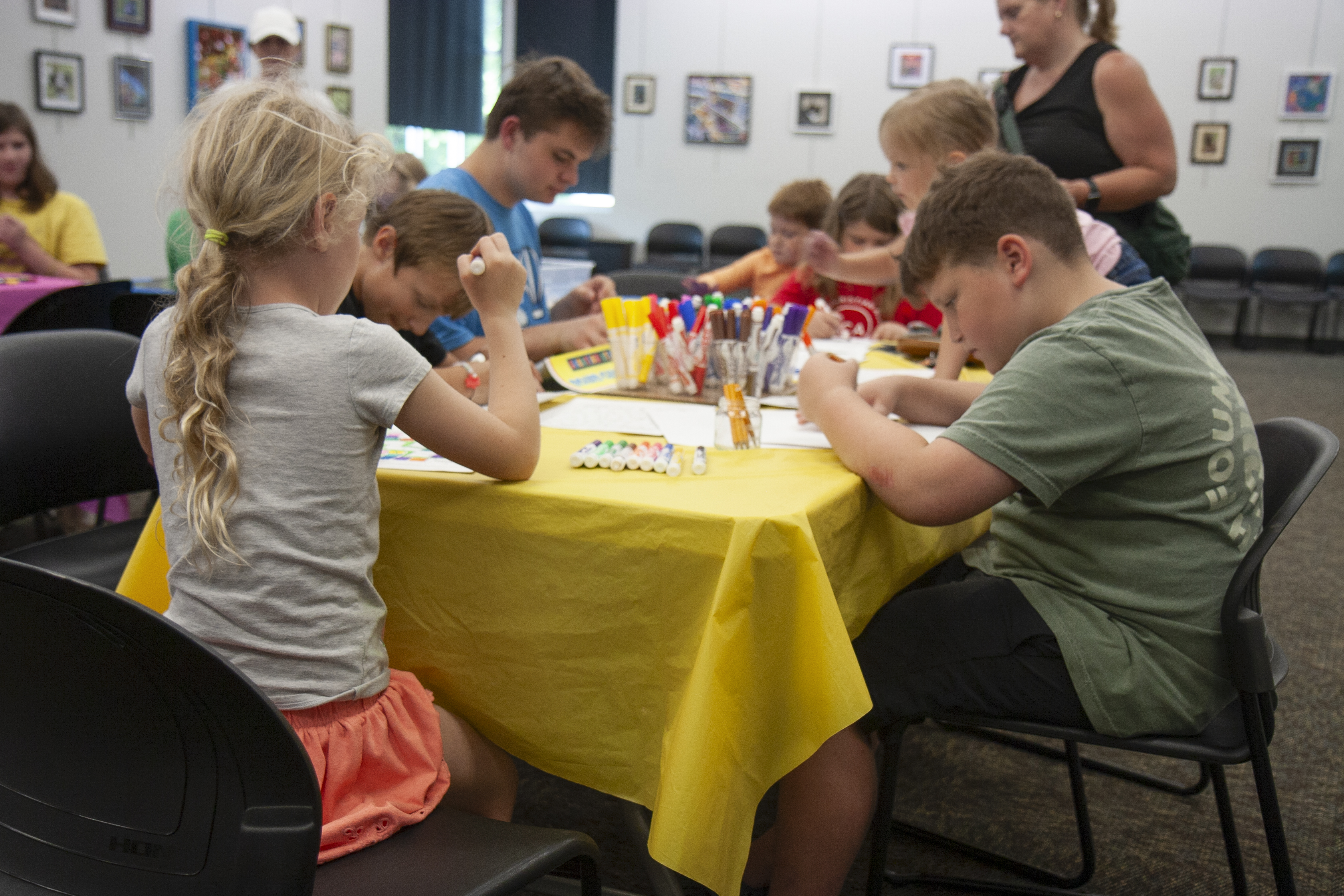 kids completing a craft at a table