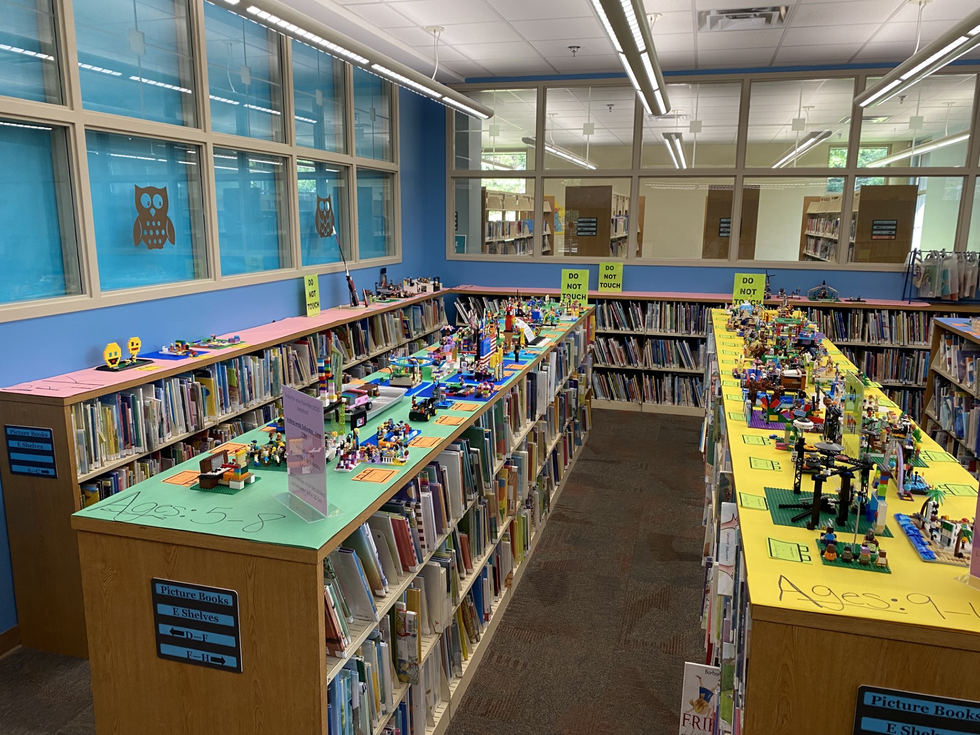 photo of LEGO creations displayed on top of library shelves
