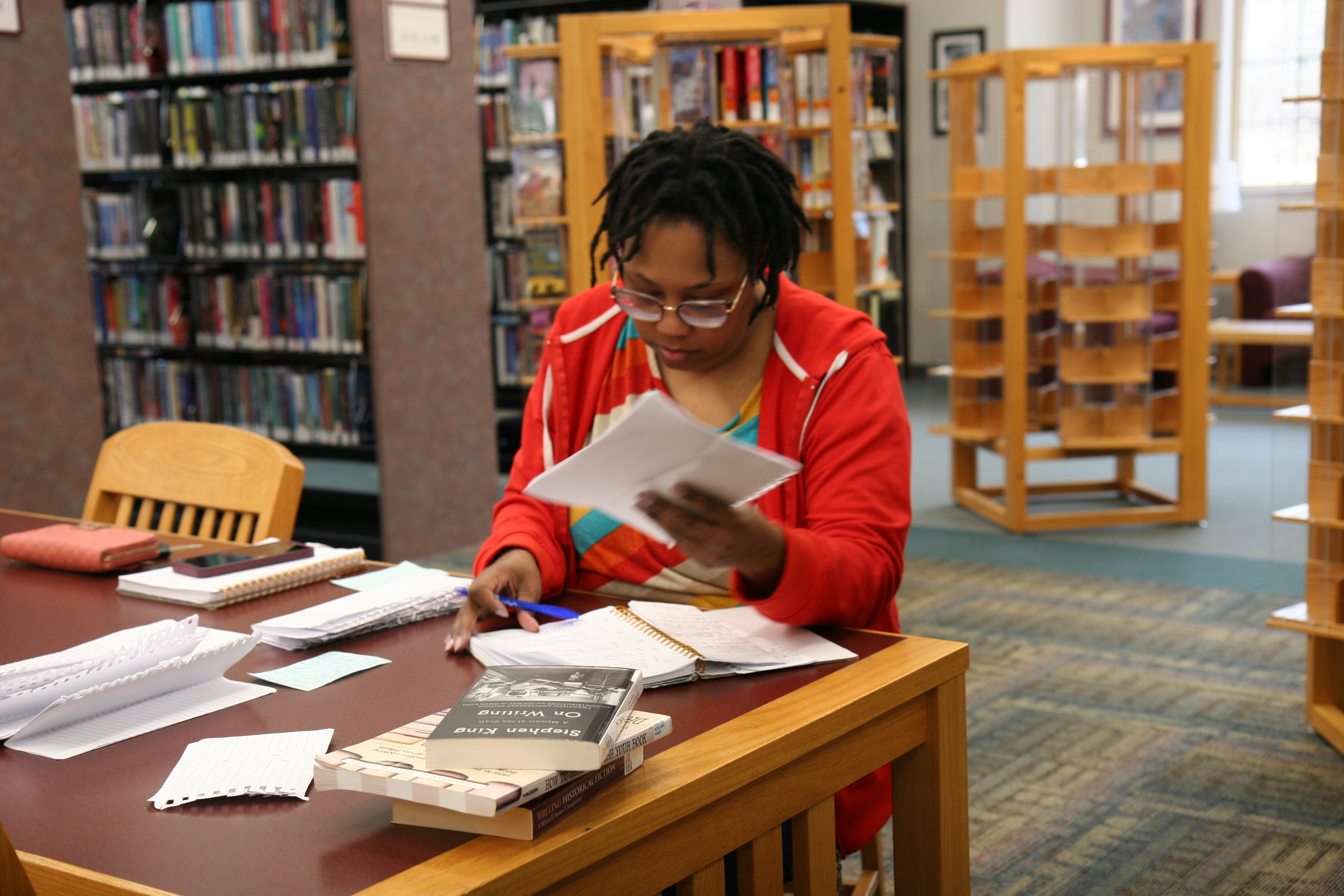 woman working at a table in a library
