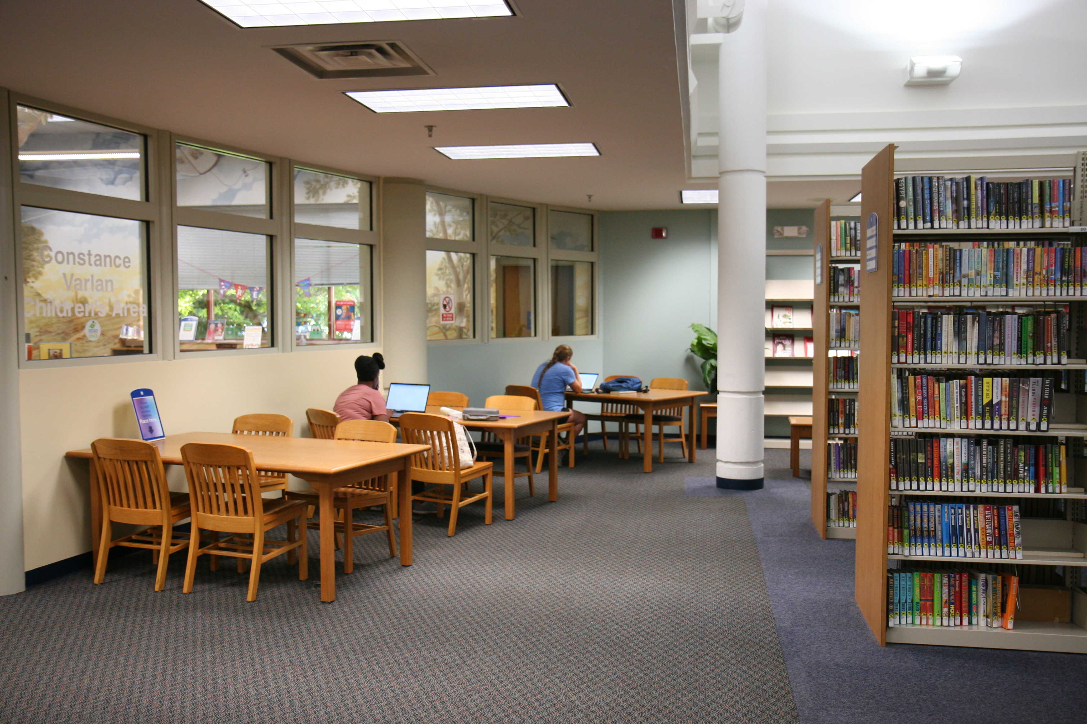 interior photo of library with tables and book shelves