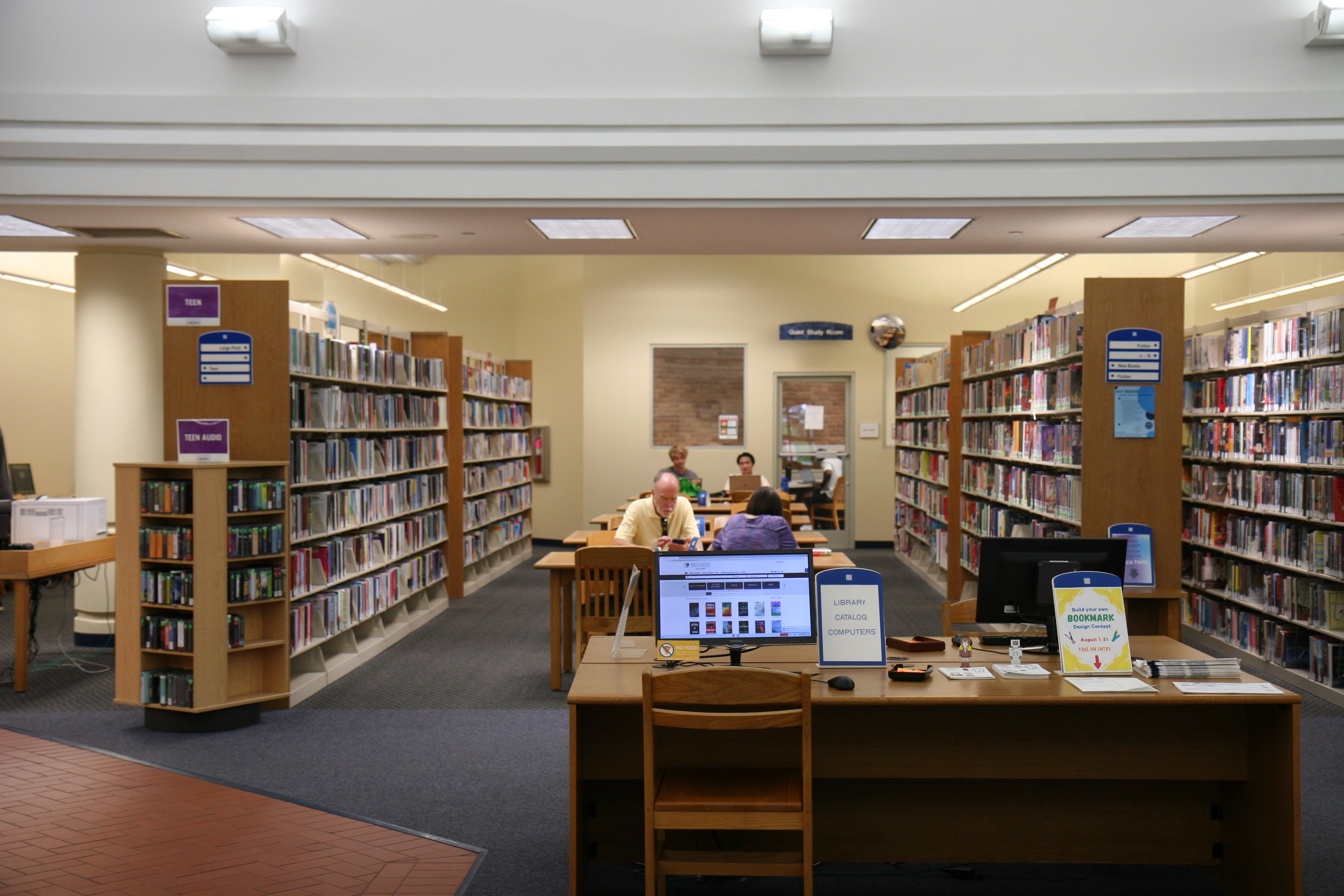 interior photo of library with tables and book shelves