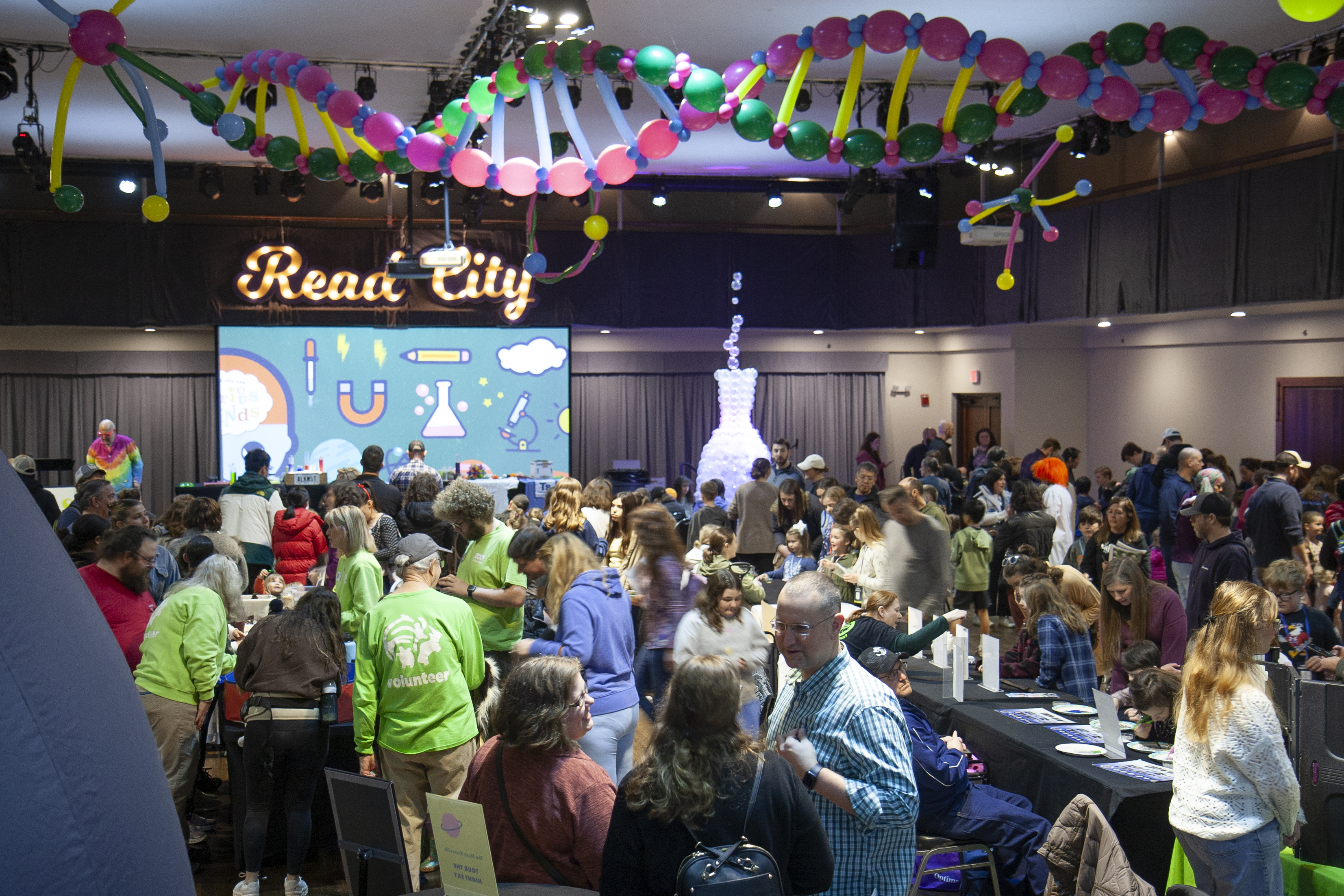 Crowd at a Read City event with DNA balloons on ceiling