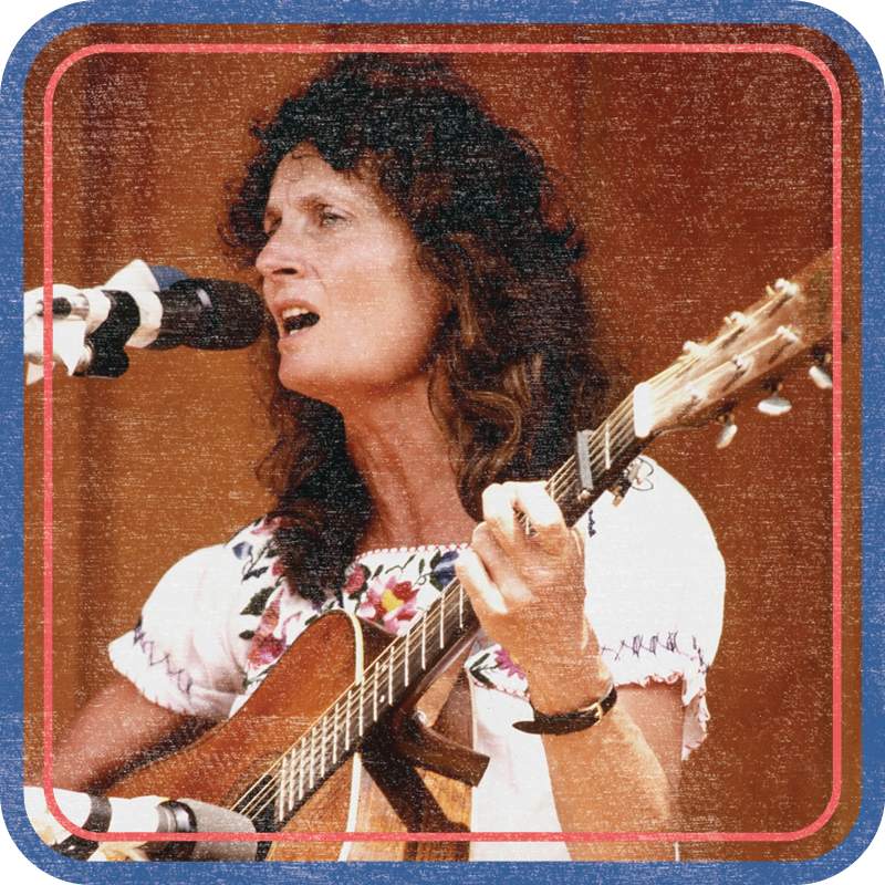 photo of Alice Gerrard playing guitar at a microphone ca 1960s