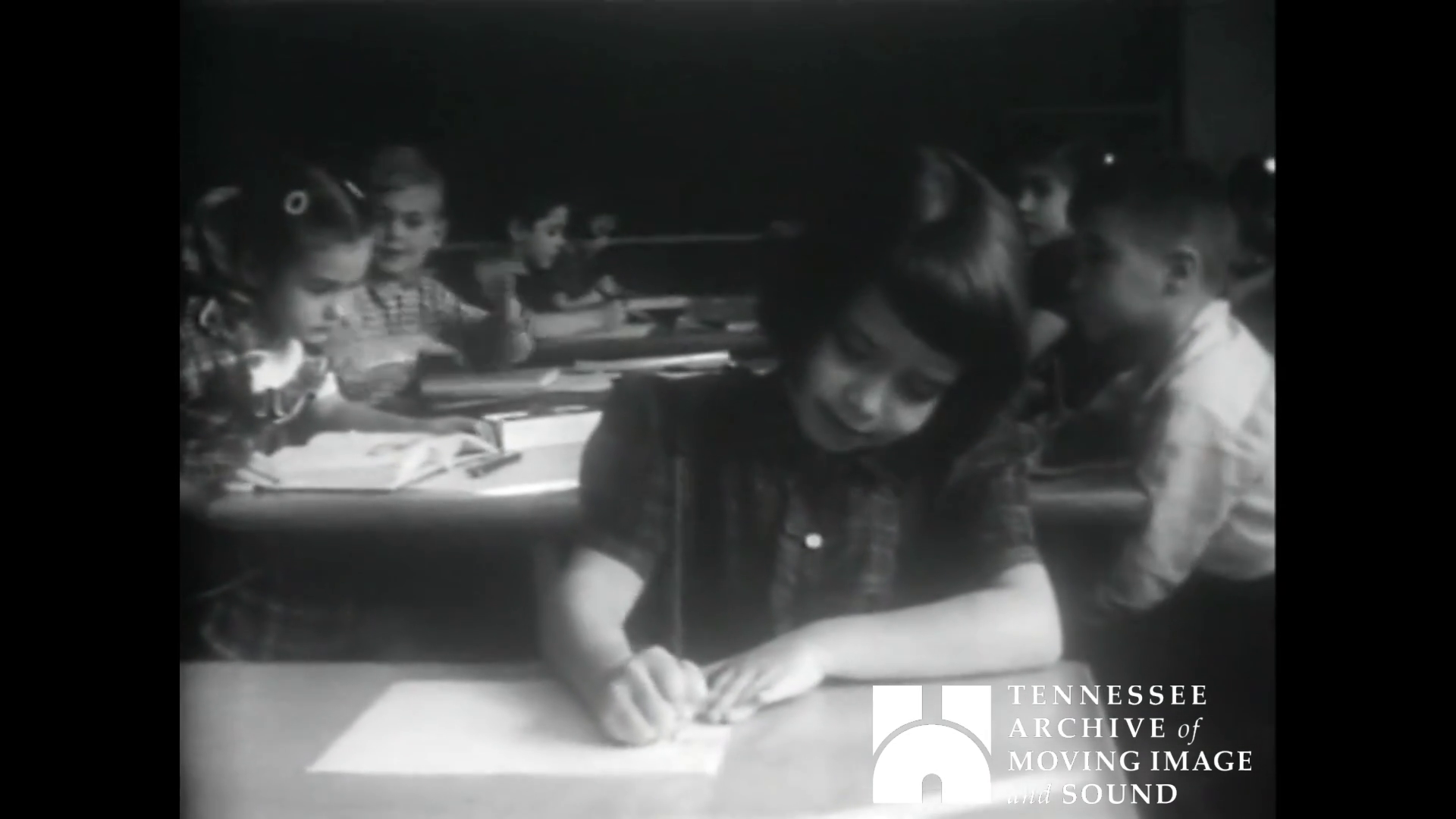 child at desk in school 1957 - black and white photo