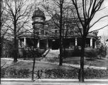 Black and white photograph of old house. 