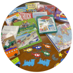 photo of books, games, puzzles, a map, and flannelboard elements