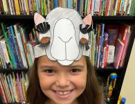 photo of young girl wearing a paper crown with a camel face