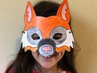 photo of smiling girl wearing a paper wolf mask