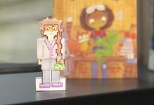photo of paper character, girl dressed in lab coat with glasses