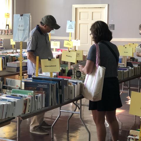 people shopping tables full of books