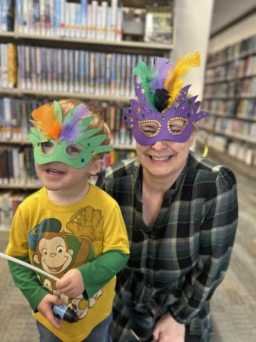 librarian with child in mardi gras masks