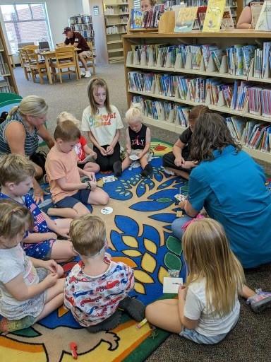 photo of preschool kids sitting on a colorful storytime carpet