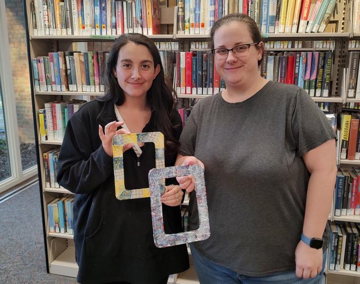 two women show a craft they made