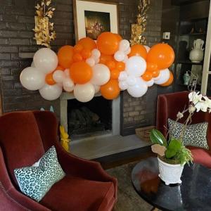 photo of orange and white balloons clustered into a garland