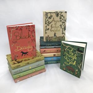 photo of stacked children's classics with vintage style illustrations and foil titles